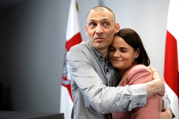 Syarhei Tsikhanouski, left, Belarusian opposition activist released from a Belarusian prison, embraces his wife, Belarusian opposition leader Sviatlana Tsikhanouskaya, after a news conference in Vilnius, Lithuania, Sunday, June 22, 2025. (AP Photo/Mindaugas Kulbis)