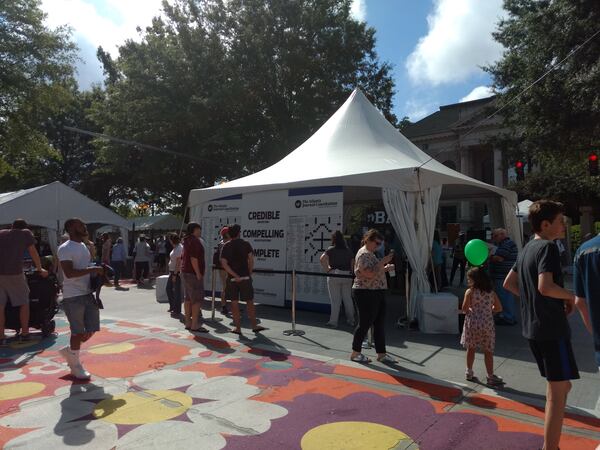 AJC's booth at the AJC Decatur Book Festival. To the left is Emory University's booth. Behind is the Historic Decatur Courthouse.