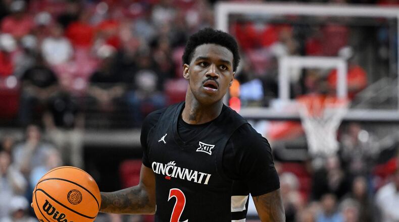 FILE - Cincinnati guard Jizzle James (2) brings the ball up court against Texas Tech during the second half of an NCAA college basketball game on Feb. 24, 2026, in Lubbock, Texas. (AP Photo/Justin Rex, File)