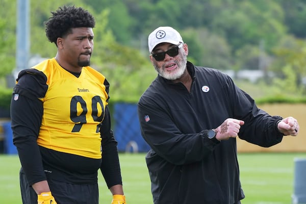 Pittsburgh Steelers first round draft pick Derrick Harmon (99) listens as defensive line coach Karl Dunbar explains a drill during the during the NFL football team's rookie camp in Pittsburgh, Friday, May 9, 2025. (AP Photo/Gene J. Puskar)