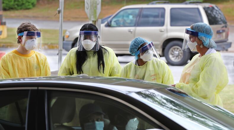 050420 Decatur: Specimen collection volunteers take free COVID-19 tests from motorists at a pop-up site at the House of Hope on Monday, May 4, in Decatur. Pastors, local physicians, health ministers, and other community leaders united to encourage area residents to get tested.  Curtis Compton ccompton@ajc.com