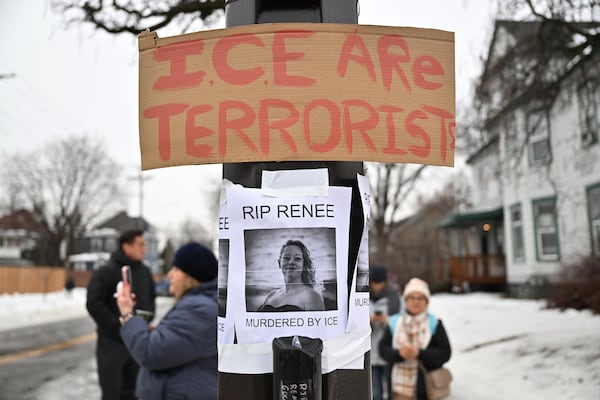 People gather around a makeshift memorial honoring the victim of a fatal shooting involving federal law enforcement agents, near the site of the shooting, Thursday, Jan. 8, 2026, in Minneapolis. (Tom Baker/AP)
