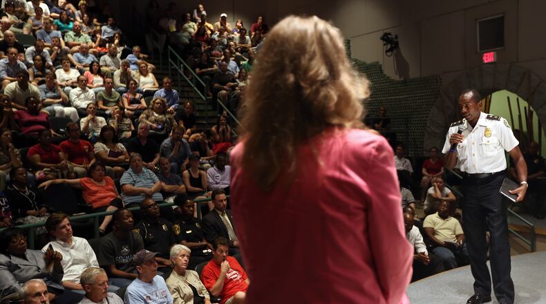 Atlanta Police Deputy Chief Shawn Jones answers a resident's question before a packed Joint Neighborhood Crime and Safety Meeting at Zoo Atlanta on July 10, 2013.