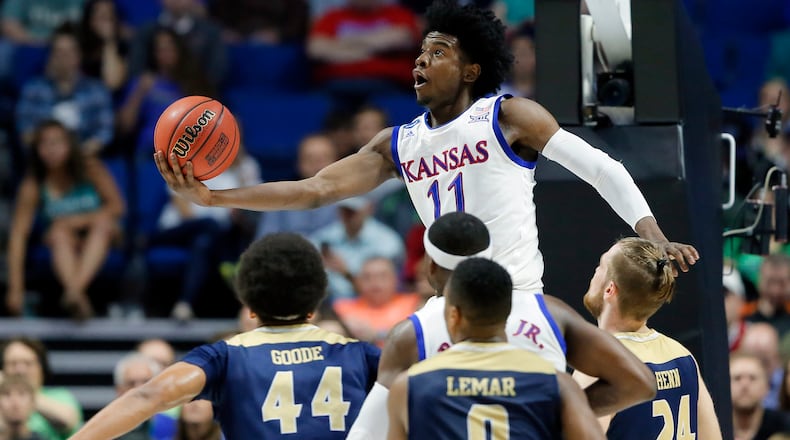 In this March 17, 2017, file photo, Kansas’s Josh Jackson (11) goes up for a shot over UC Davis’s Garrison Goode (44), Brynton Lemar (0) and Mikey Henn (24) in the first half of a first-round game in the men’s NCAA college basketball tournament in Tulsa, Okla. Jackson spent one season at Kansas and is expected to be a top-five pick in Thursday’s NBA draft. (AP Photo/Tony Gutierrez, File)