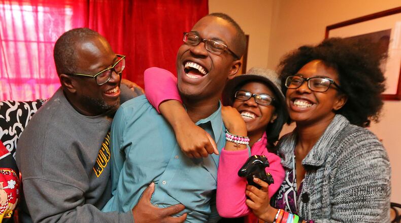 Omar, now 20, gets a ribbing from his father, Garry, and sisters, Devyne (in hat), 14, and Eryn, 16, after winning a video game. "We are very proud of Omar," said his father. "I always told Omar if you believe in yourself, the sky is the limit."