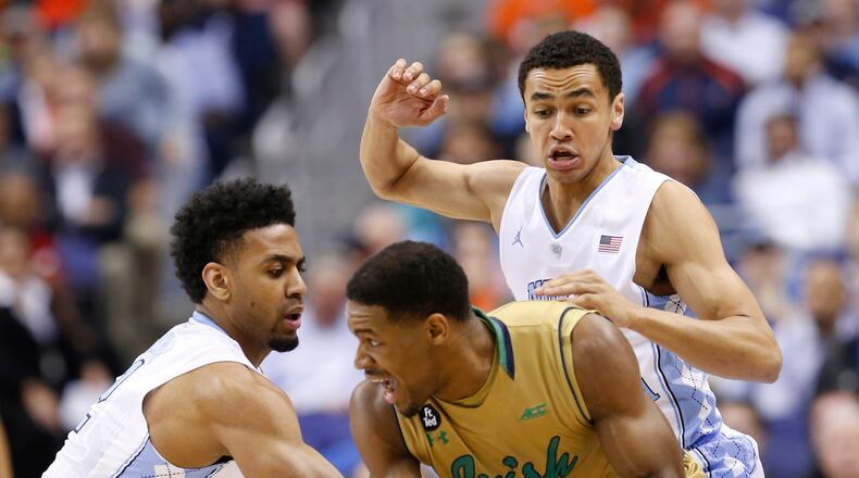 CORRECTS NOTRE DAME PLAYER TO DEMTRIUS JACKSON, INSTEAD OF BRICE JOHNSON - North Carolina's Joel Berry II, left, and Marcus Paige, right, pressure Notre Dame forward Demtrius Jackson during the first half of an NCAA college basketball game in the Atlantic Coast Conference men's tournament, Friday, March 11, 2016, in Washington. (AP Photo/Steve Helber)