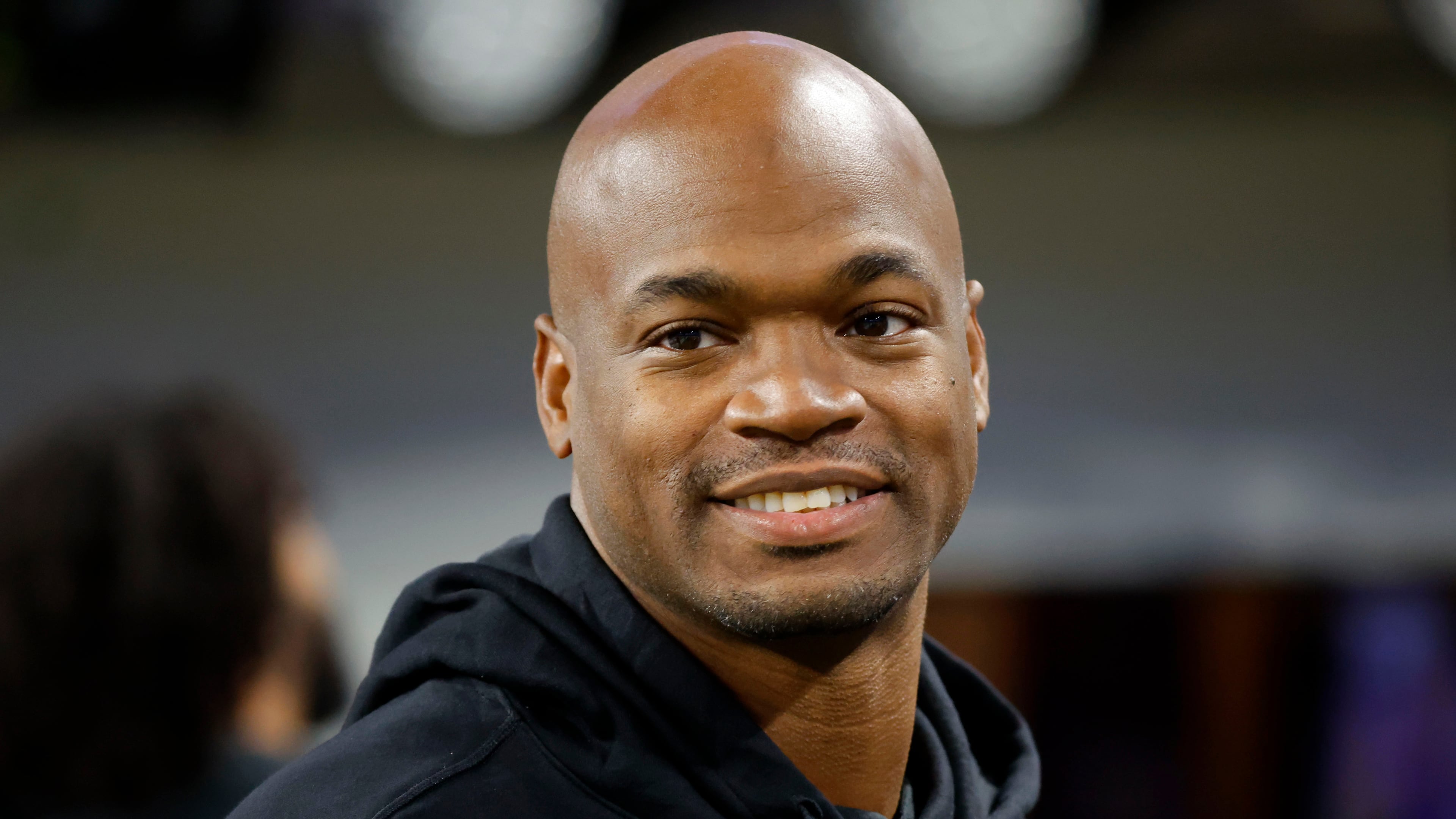 FILE - Former Minnesota Vikings running back Adrian Peterson stands on the field before an NFL football game between the Vikings and the Chicago Bears, Nov. 27, 2023, in Minneapolis. (AP Photo/Bruce Kluckhohn, File)