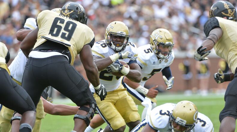 September 17, 2016 Atlanta - Georgia Tech Yellow Jackets running back Dedrick Mills (26) runs against Vanderbilt Commodores defensive lineman Adam Butler (69) in the second half at Bobby Dodd Stadium on Saturday, September 17, 2016. Georgia Tech Yellow Jackets won 38-7 over the Vanderbilt Commodores. HYOSUB SHIN / HSHIN@AJC.COM