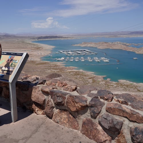 A tourist takes a photo of Lake Mead near Boulder City, Nev., on Friday, Aug. 7, 2026. (AP Photo/Ty ONeil)