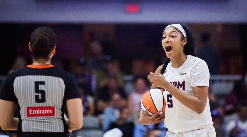 Dream All-Star Angel Reese, right, has 25 double-doubles this season, including Saturday's performance with 31 points and 14 rebounds. (Sammy Kogan/The Canadian Press via AP)