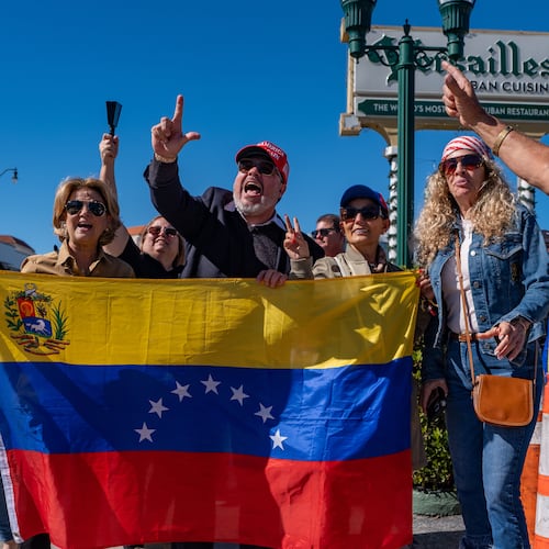 People celebrate outside Versailles Cuban Cuisine after President Donald Trump announced Venezuelan President Nicolás Maduro had been captured and flown out of the country, in Miami, Saturday, Jan. 3, 2026. (AP Photo/Jen Golbeck)