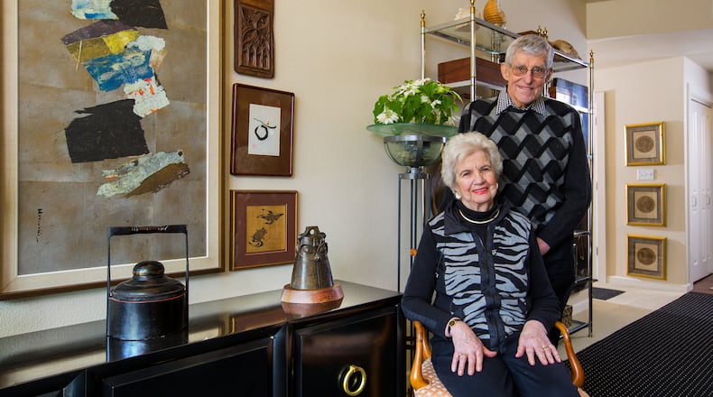 Jim Halverson, a retired interior designer, and his wife, Darlene, live in the Mirabella Seattle retirement community with their amazing 60-year collection of art and memories. The small wood piece, at top, is a fragment from a church in Belgium, dated 1380. The painting at far left is by Paul Horiuchi. “It had been a horizontal collage,” Darlene says. “It works better vertically, so what the heck.” She’s sitting in one of two hand-carved 1959 Venice chairs, which they bought for $25 apiece. “We wouldn’t ever part with these. We’ve recovered them a couple of times,” she says. (Mike Siegel/The Seattle Times/TNS)