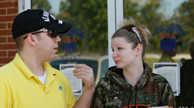 Chris Tubbs (left) and Chandy Lee leave the Rome Social Security office after being turned away on Oct. 1, 2013. Lee wanted to make a name change. The Social Security office in Rome remained open, offering limited services.
