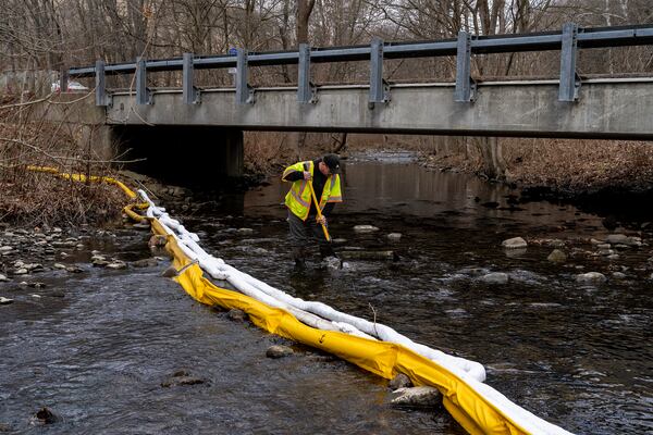 Ron Fodo, Ohio EPA Emergency Response, looks for signs of fish in Leslie Run creek to check for chemicals that might have settled at the bottom following the Norfolk Southern train derailment in Ohio. (Michael Swensen/Getty 2023)