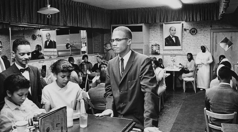 African-American Muslim minister and civil rights activist Malcolm X (1925 - 1965) at Temple 7, a Halal restaurant patronized by black Muslims, on Lenox Avenue and 116th Street, Harlem, New York, August 1963. (Photo by Richard Saunders/Pictorial Parade/Archive Photos/Getty Images)