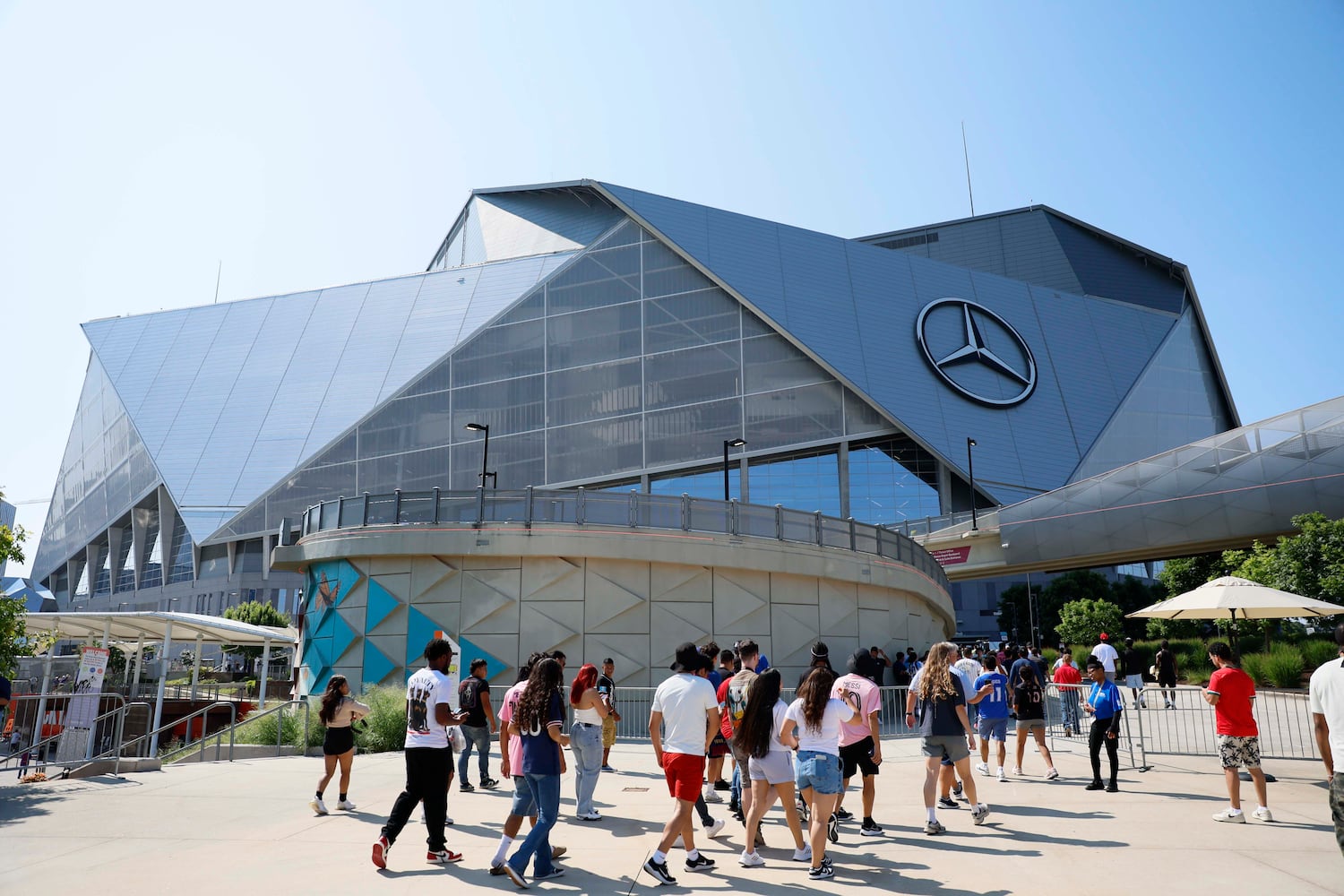 Fans walks towards the Mercedes-Benz Stadium prior to the round of 16 soccer match between Paris Saint-Germain FC and Inter Miami in Atlanta, Georgia, on Sunday, June 29, 2025.
(Miguel Martinez/ AJC)