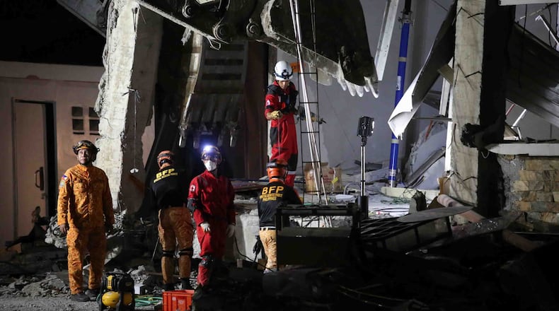 Rescuers use heavy equipment as they conduct a search and retrieval operation at a damaged building following an earthquake in General Santos, Philippines, Tuesday, June 9, 2026. (AP Photo/Basilio Sepe)