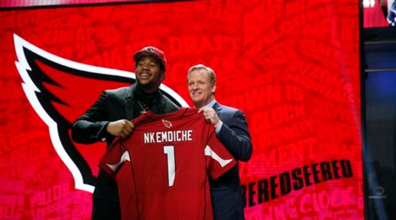 Mississippi�s Robert Nkemdiche poses for photos with NFL commissioner Roger Goodell after being selected by the Arizona Cardinals as the 30th pick in the first round of the 2016 NFL football draft, Thursday, April 28, 2016, in Chicago. (AP Photo/Charles Rex Arbogast)