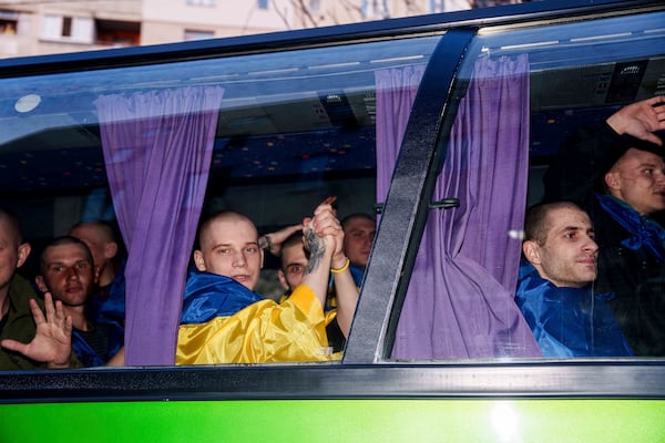 Ukrainian servicemen ride in a bus after returning from captivity in a POW exchange in Ukraine, on Saturday, April. 19, 2025. (AP Photo/Evgeniy Maloletka)