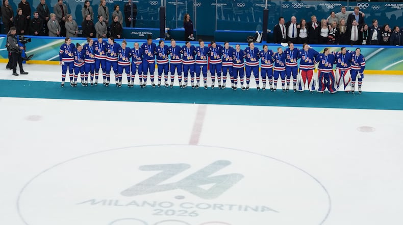 United States players and coaches stand during the playing of the national anthem after winning the women's ice hockey gold medal game at the 2026 Winter Olympics, in Milan, Italy, Thursday, Feb. 19, 2026. (AP Photo/Carolyn Kaster)