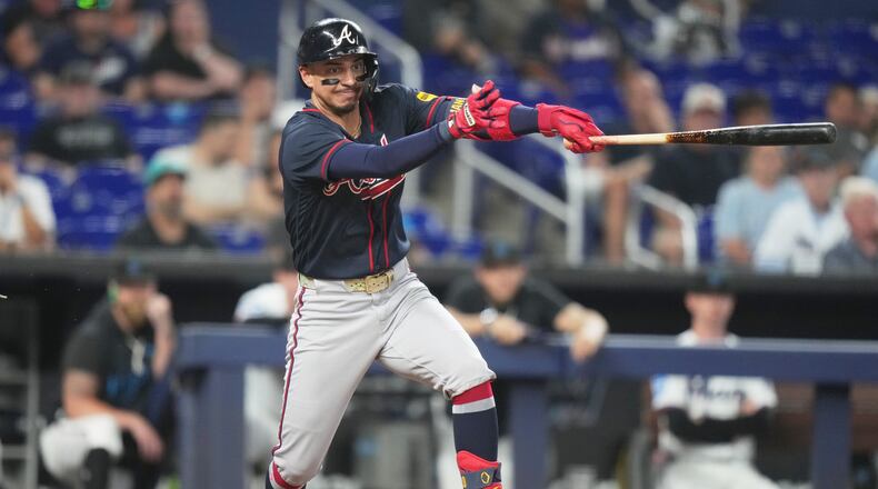 Atlanta Braves' Mauricio Dubón hits a RBI single to score Mike Yastrzemski during the eighth inning of a baseball game against the Miami Marlins, Tuesday, May 19, 2026, in Miami. (AP Photo/Lynne Sladky)
