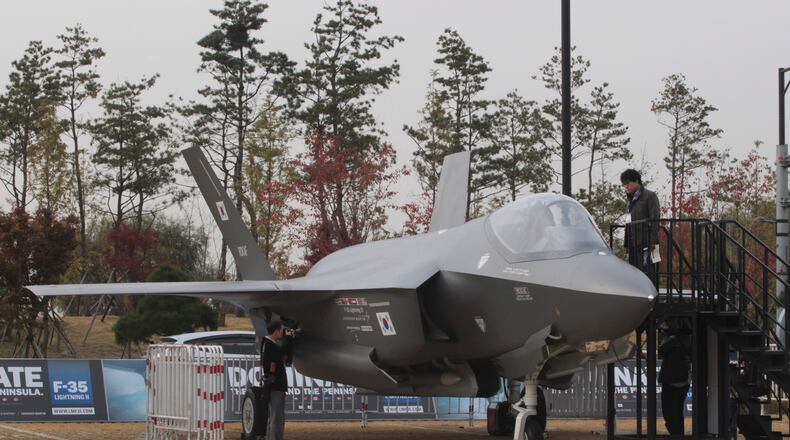 A photographer takes pictures of Lockheed Martin F-35 Lighting II during a media day of Seoul International Aerospace and Defense Exhibition (ADEX) 2013 in Goyang, South Korea, Monday, Oct. 28, 2013. About 360 defense firms from 28 countries participate in the biennial international aerospace and defense exhibition from Oct. 29 to Nov. 3. (AP Photo/Ahn Young-joon)