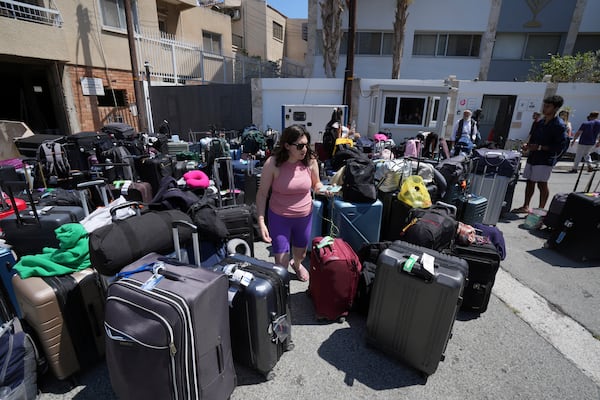 Luggage of evacuees from Israel are seen outside of a Jews community center, after their arrival from Israel to the port of Larnaca, Cyprus, Wednesday, June 18, 2025. (AP Photo/Petros Karadjias)