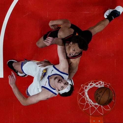 Atlanta Hawks guard Dyson Daniels (5) shoots against Golden State Warriors center Quinten Post (21) during the first half of an NBA basketball game, Saturday, March 21, 2026, in Atlanta. (AP Photo/Mike Stewart)