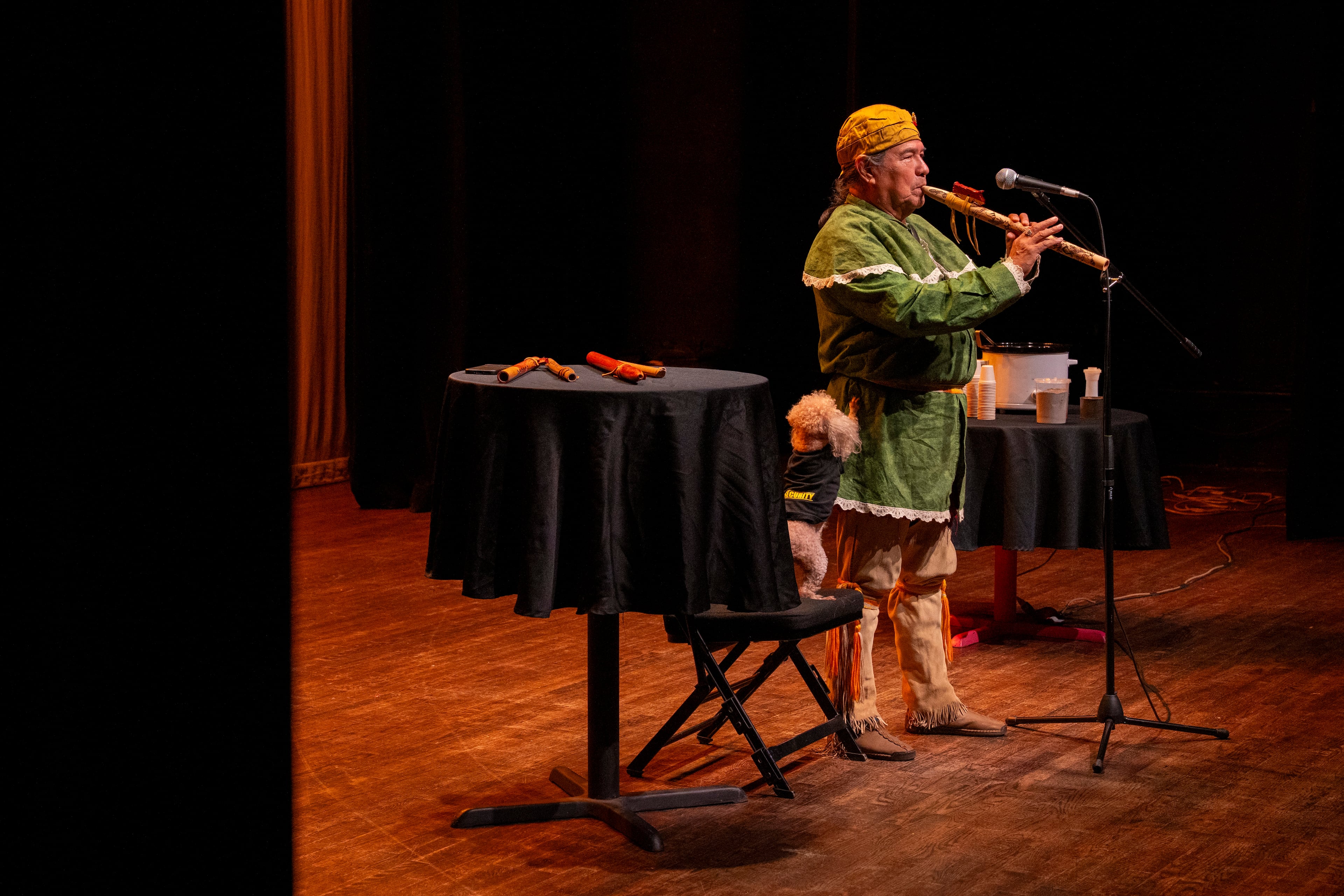 Muscogee (Creek) elder William Harjo plays a flute he made by hand and tells stories at the Art of Activism at 7 Stages Theatre in Atlanta on Friday, Nov. 14, 2025. (Olivia Bowdoin for the AJC)