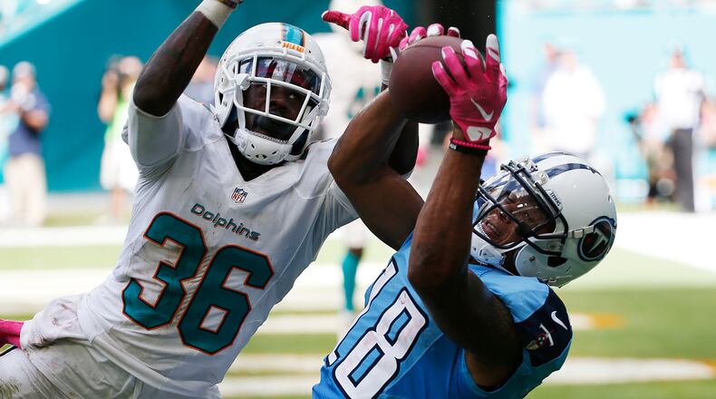 Tennessee Titans wide receiver Rishard Matthews (18) catches a pass for a touchdown as Miami Dolphins cornerback Tony Lippett (36), defends, during the second half of an NFL football game, Sunday, Oct. 9, 2016, in Miami Gardens, Fla. (AP Photo/Wilfredo Lee)