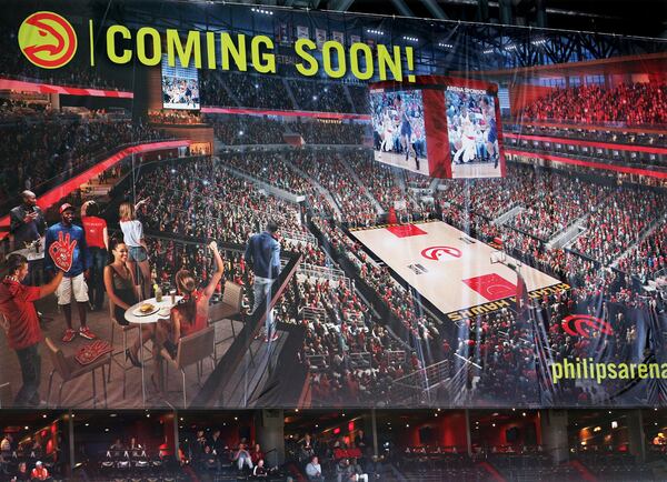 A large banner covers renovations taking place on the seventh, eighth and ninth floors of Philips Arena just above spectators in suites on the sixth floor. CURTIS COMPTON / CCOMPTON@AJC.COM