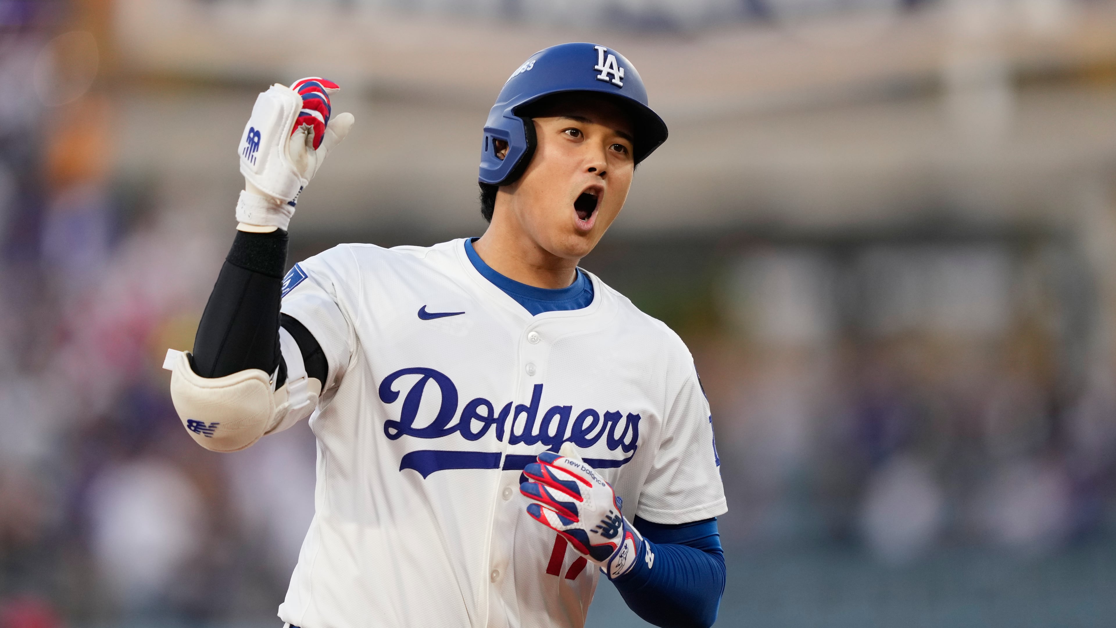 Los Angeles Dodgers' Shohei Ohtani celebrates as he rounds the bases after his solo home run during the first inning in Game 1 of the National League Wild Card baseball playoff series against the Cincinnati Reds, Tuesday, Sept. 30, 2025, in Los Angeles. (AP Photo/Mark J. Terrill)