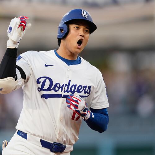 Los Angeles Dodgers' Shohei Ohtani celebrates as he rounds the bases after his solo home run during the first inning in Game 1 of the National League Wild Card baseball playoff series against the Cincinnati Reds, Tuesday, Sept. 30, 2025, in Los Angeles. (AP Photo/Mark J. Terrill)