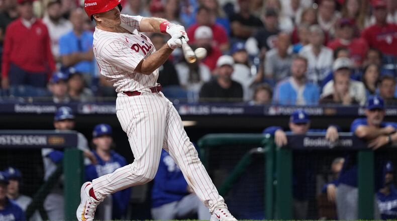FILE - Philadelphia Phillies' J.T. Realmuto hits a double during the ninth inning in Game 2 of baseball's National League Division Series against the Los Angeles Dodgers, Monday, Oct. 6, 2025, in Philadelphia. (AP Photo/Matt Slocum, File)