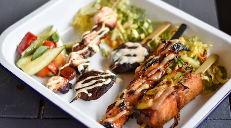 A selection of yakitori at Whiskey Bird, including (from left to right) charred octopus, shiitake mushroom, sticky soy chicken and pork belly. CONTRIBUTED BY HENRI HOLLIS