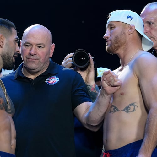UFC commentator Joe Rogan, center, with Ilia Topuria, left, and Justin Gaethje, right, during the ceremonial UFC Freedom 250 weigh-ins on the Ellipse, Saturday, June 13, 2026, in Washington, ahead of Sunday's fight on the South Lawn of the White House. (AP Photo/Julia Demaree Nikhinson)