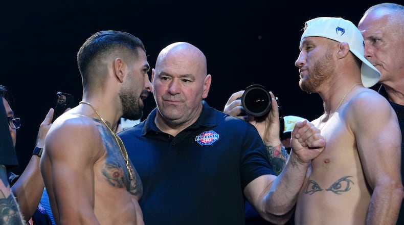 UFC commentator Joe Rogan, center, with Ilia Topuria, left, and Justin Gaethje, right, during the ceremonial UFC Freedom 250 weigh-ins on the Ellipse, Saturday, June 13, 2026, in Washington, ahead of Sunday's fight on the South Lawn of the White House. (AP Photo/Julia Demaree Nikhinson)