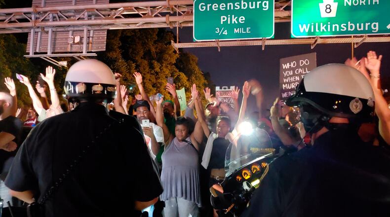 Pittsburgh police are searching for the driver of a car that plowed into a group of protesters Friday night, demonstrating against police use of force in the shooting death of 17-year-old Antwon Rose.