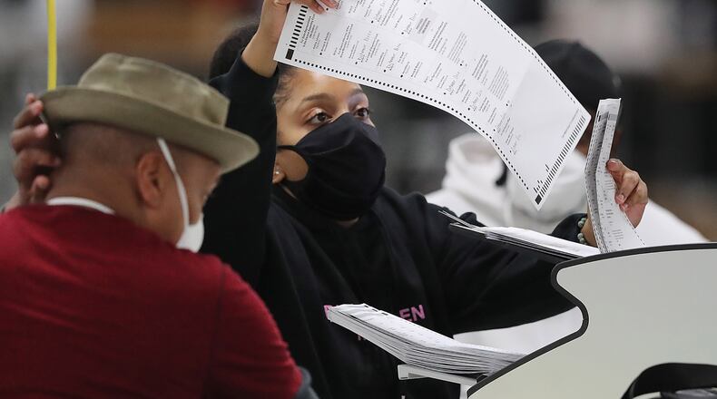 DeKalb Voter Registration and Elections workers begin scanning ballots to electronically recount more than 373,000 votes by the state-mandated deadline on Tuesday, Nov. 24, 2020, in Stonecrest, Georgia. (Curtis Compton/Atlanta Journal-Constitution/TNS)