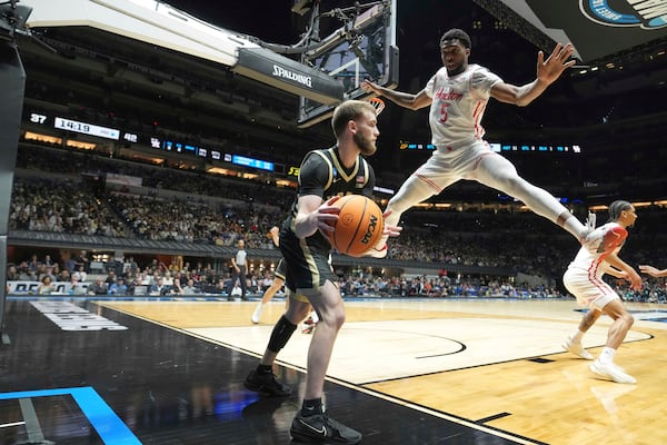 Purdue's Braden Smith, left, tries to inbound the ball as Houston's Ja'Vier Francis (5) defends during the second half in the Sweet 16 of the NCAA college basketball tournament Friday, March 28, 2025, in Indianapolis. (AP Photo/Michael Conroy)