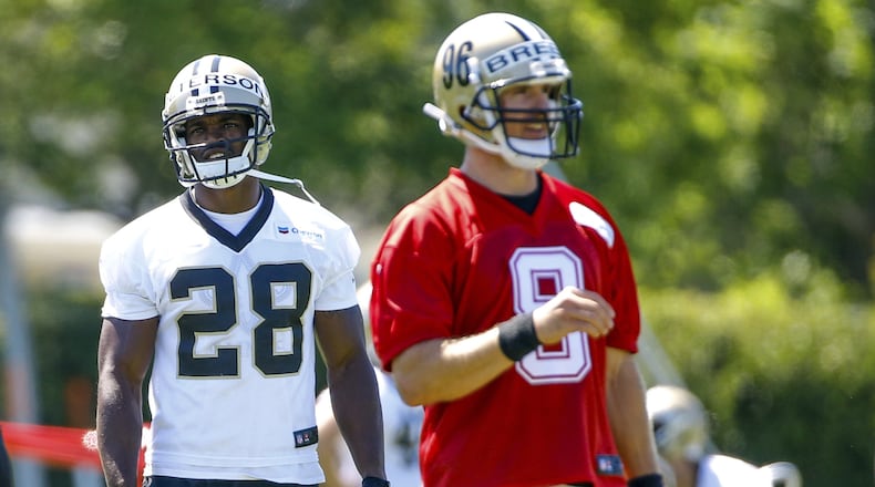 New Orleans Saints running back Adrian Peterson (28) stands behind quarterback Drew Brees (9) during NFL football practice in Metairie, La., Thursday, May 25, 2017. (AP Photo/Derick E. Hingle)