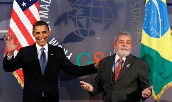 FILE - U.S. President Barack Obama, left, and Brazil's President Luiz Inacio Lula da Silva, react during the G8 Summit in L'Aquila, Italy, July 9, 2009. (AP Photo/Haraz N. Ghanbari, File)