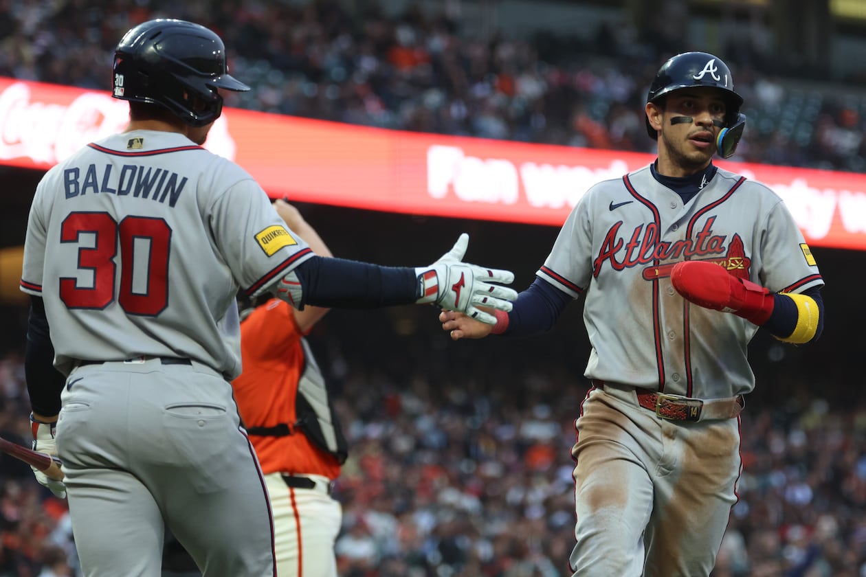 Atlanta Braves' Mauricio Dubón, right, is congratulated by Drake Baldwin (30) after scoring on a single by Ozzie Albies during the third inning of a baseball game against the San Francisco Giants in San Francisco, Friday, June 26, 2026. (AP Photo/Jed Jacobsohn)