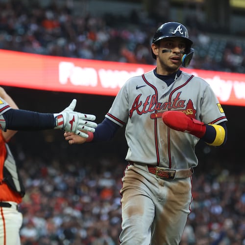 Atlanta Braves' Mauricio Dubón, right, is congratulated by Drake Baldwin (30) after scoring on a single by Ozzie Albies during the third inning of a baseball game against the San Francisco Giants in San Francisco, Friday, June 26, 2026. (AP Photo/Jed Jacobsohn)