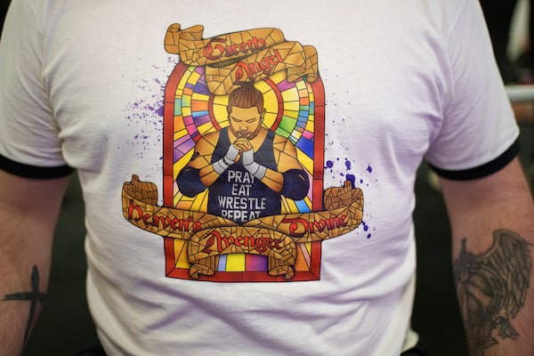 A detail is seen on the shirt of Gareth 'Angel' Thompson, founder of the Kingdom Wrestling charity at St Peter's Church in Shipley after one of the charity's monthly wrestling shows, Saturday, March 29, 2025. (AP Photo/Jon Super)