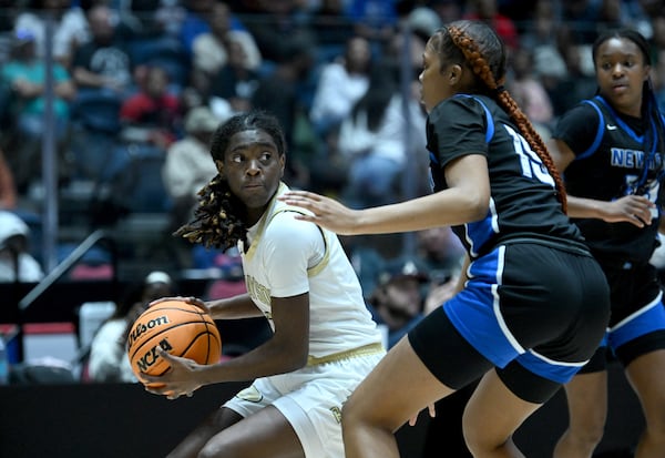 Grayson's Coco Rudolph (left) drives against Newton's Jamira Flournoy (15) during the first half of the GHSA Girls 6A State Championship at the Macon Centreplex, Saturday, March 8, 2025, in Macon. (Hyosub Shin / AJC)