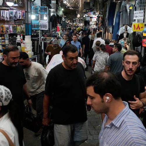 People walk in Tehran's traditional main bazaar, Iran, Saturday, Aug. 8, 2026. (AP Photo/Vahid Salemi)