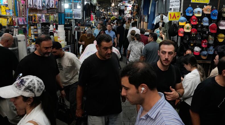 People walk in Tehran's traditional main bazaar, Iran, Saturday, Aug. 8, 2026. (AP Photo/Vahid Salemi)