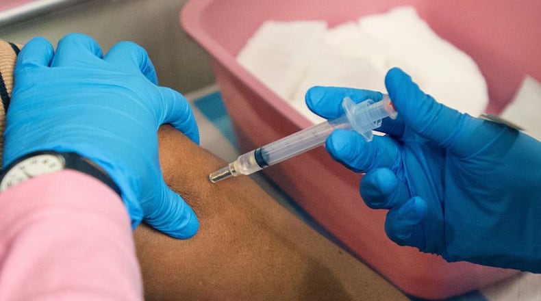 A patient receives a flu shot.