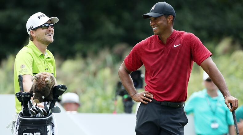 Tiger Woods (right) talks to Austin Cook on the 12th tee during the final round of The Northern Trust on August 26, 2018 at the Ridgewood Championship Course in Ridgewood, New Jersey. (Photo by Gregory Shamus/Getty Images)